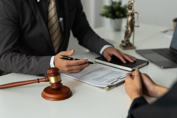 businesswoman-and-female-lawyer-or-judge-consult-having-team-meeting-with-client-law-and-treaty-of-the-law-sign-a-contract-business-free-photo